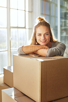Buy stock photo Shot of a young woman moving into her new home