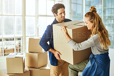 Buy stock photo Shot of a young couple moving into their new home
