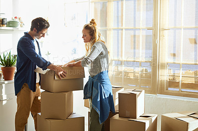 Buy stock photo Shot of a young couple moving into their new home