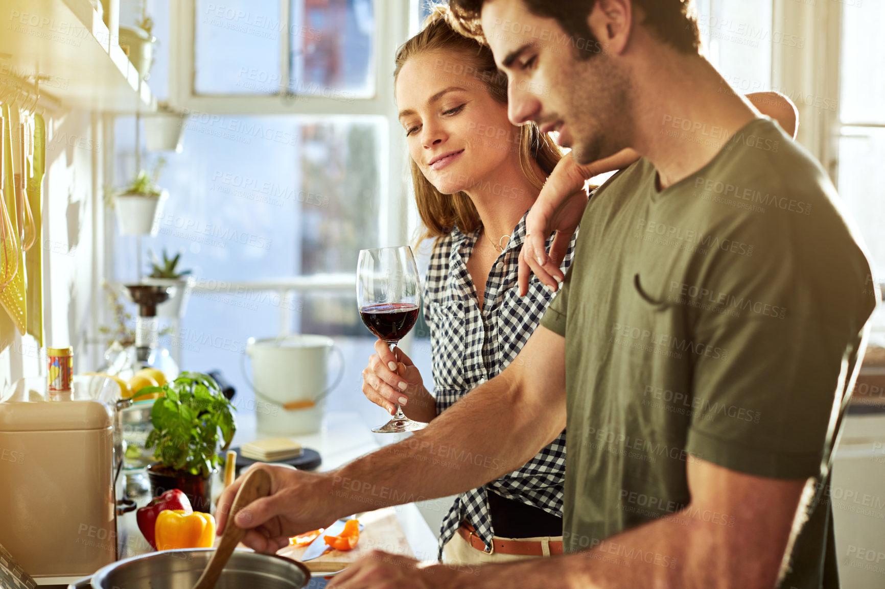 Buy stock photo Shot of a young couple preparing a meal together at home