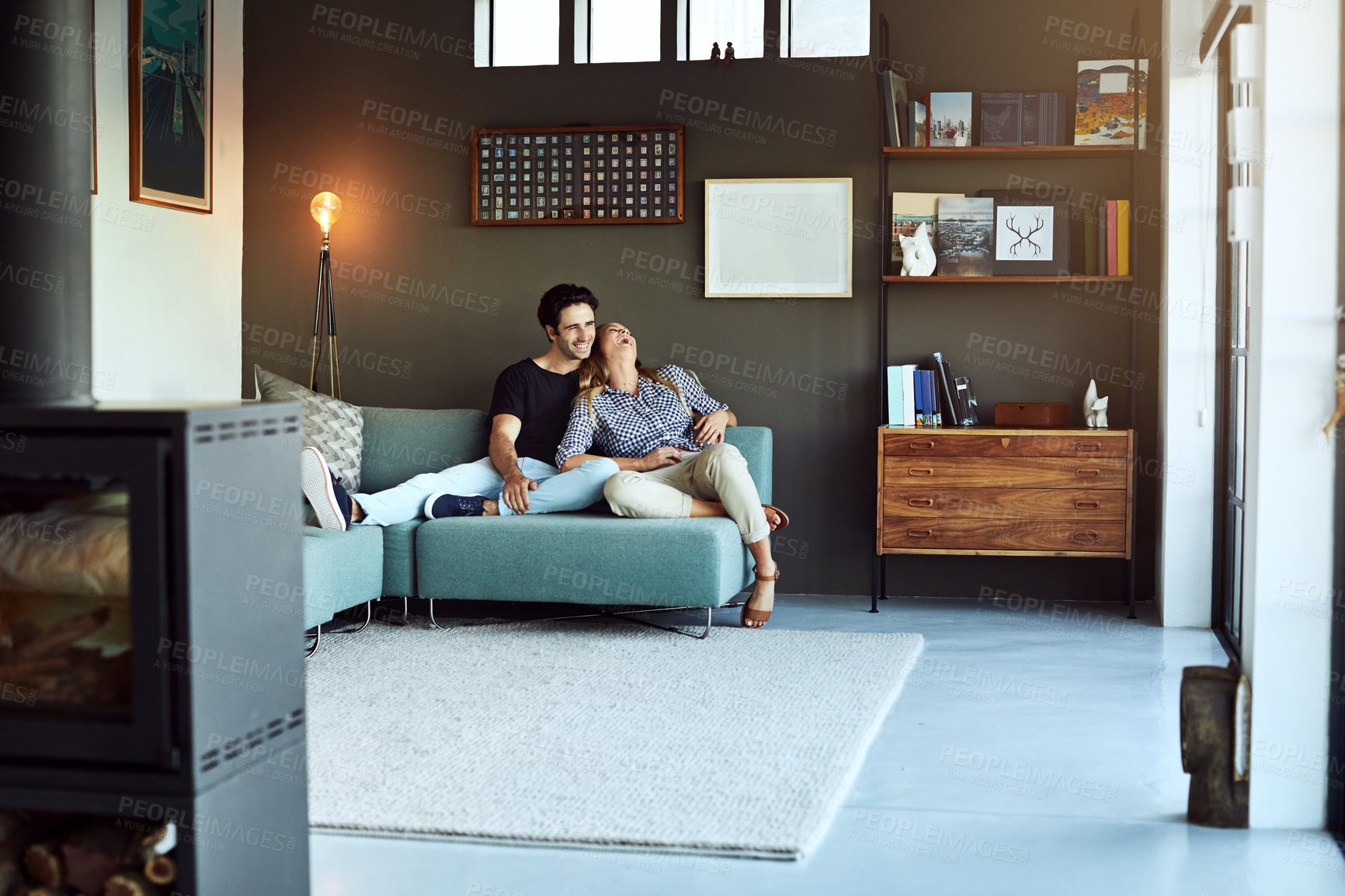 Buy stock photo Couple, happiness and relax on couch for bonding, quality time and laughing in conversation in home. Man, woman and rest together in lounge with joke, funny chat and cozy with relationship wellness