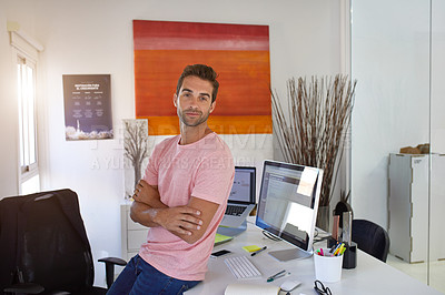 Buy stock photo Shot of a handsome young man in his office