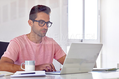 Buy stock photo Cropped shot of a young designer working on his laptop