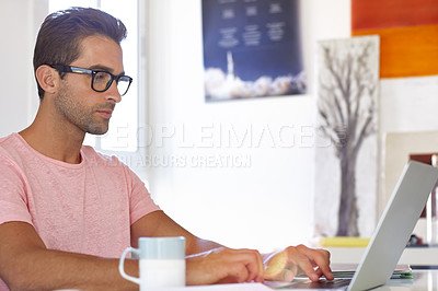 Buy stock photo Cropped shot of a young designer working on his laptop