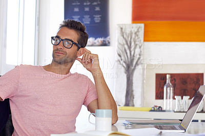 Buy stock photo Cropped shot of a young businessman sitting at his desk
