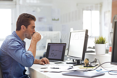 Buy stock photo Shot of a handsome young man working in an office