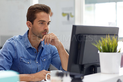 Buy stock photo Shot of a handsome young man working in an office