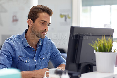 Buy stock photo Shot of a handsome young man working in an office