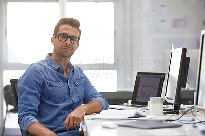 Buy stock photo Shot of a handsome young man working in an office