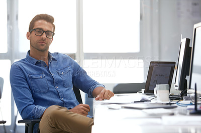 Buy stock photo Shot of a handsome young man working in an office