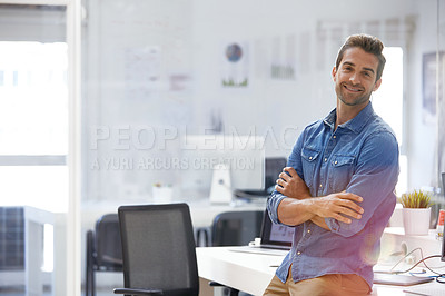 Buy stock photo Shot of a confident young man in his office