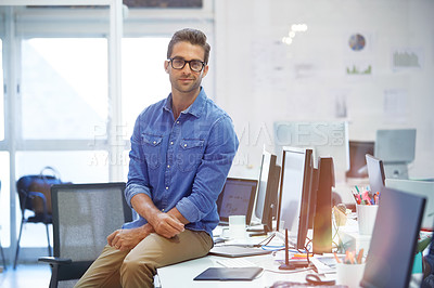 Buy stock photo Shot of a confident young man in his office