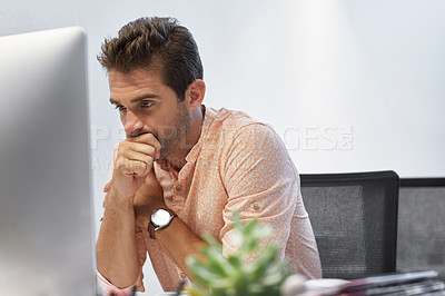 Buy stock photo Shot of a businessman looking exhausted while sitting at his desk