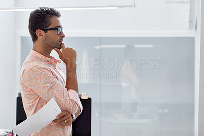 Buy stock photo Shot of a young businessman working in his office