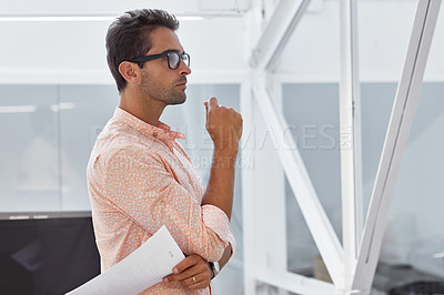 Buy stock photo Shot of a young businessman working in his office