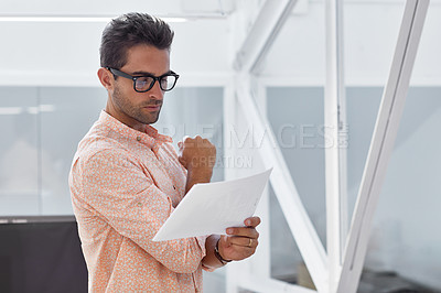 Buy stock photo Shot of a young businessman working in his office