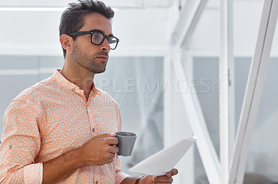 Buy stock photo Shot of a young businessman working in his office
