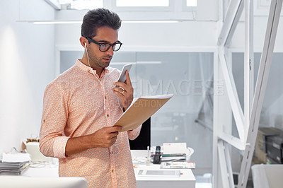 Buy stock photo Shot of a young businessman working in his office