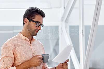 Buy stock photo Shot of a young businessman working in his office