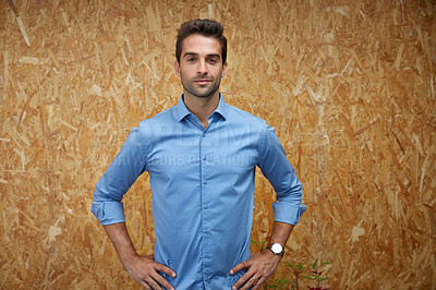 Buy stock photo Cropped shot of a handsome young man posing against a wooden wall