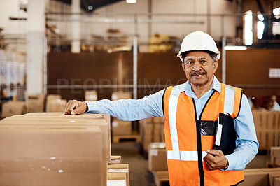 Buy stock photo Shot of a confident mature man working in a warehouse