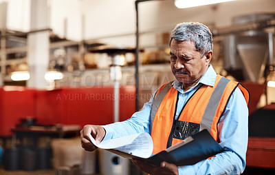 Buy stock photo Shot of a mature man doing inventory in a warehouse