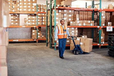 Buy stock photo Shot of a mature man moving boxes in a warehouse