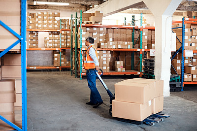 Buy stock photo Shot of a mature man moving boxes in a warehouse