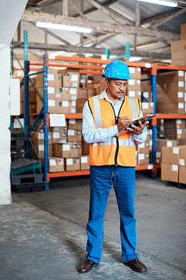Buy stock photo Shot of a mature man doing inventory in a warehouse