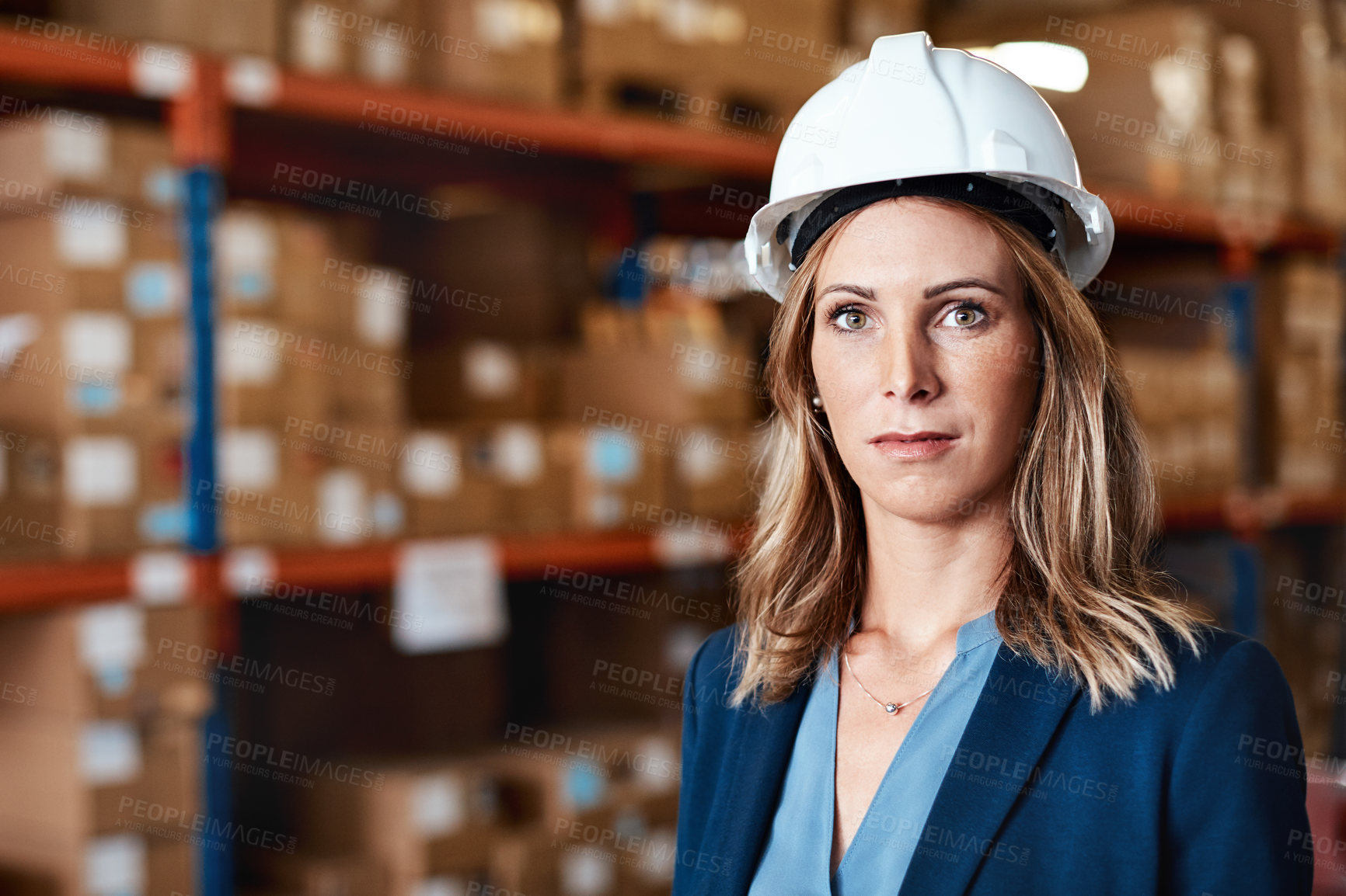 Buy stock photo Shot of a confident young woman working in a warehouse