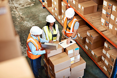 Buy stock photo High angle shot of a group of factory workers having a discussion in a warehouse
