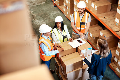 Buy stock photo High angle shot of a group of factory workers having a discussion in a warehouse