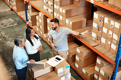 Buy stock photo High angle shot of a group of factory workers having a discussion in a warehouse