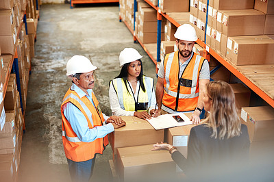 Buy stock photo High angle shot of a group of factory workers having a discussion in a warehouse