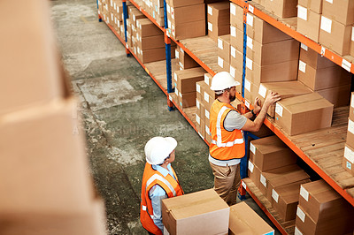 Buy stock photo High angle shot of two men working in a warehouse