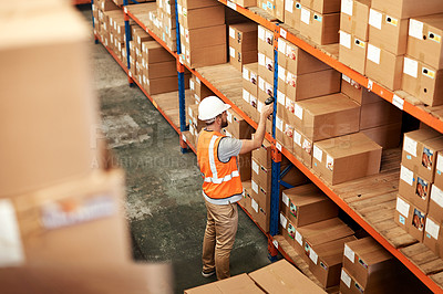 Buy stock photo High angle shot of a young man using a barcode reader in a warehouse