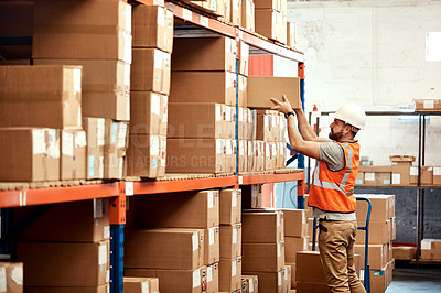 Buy stock photo Shot of a young man working in a warehouse