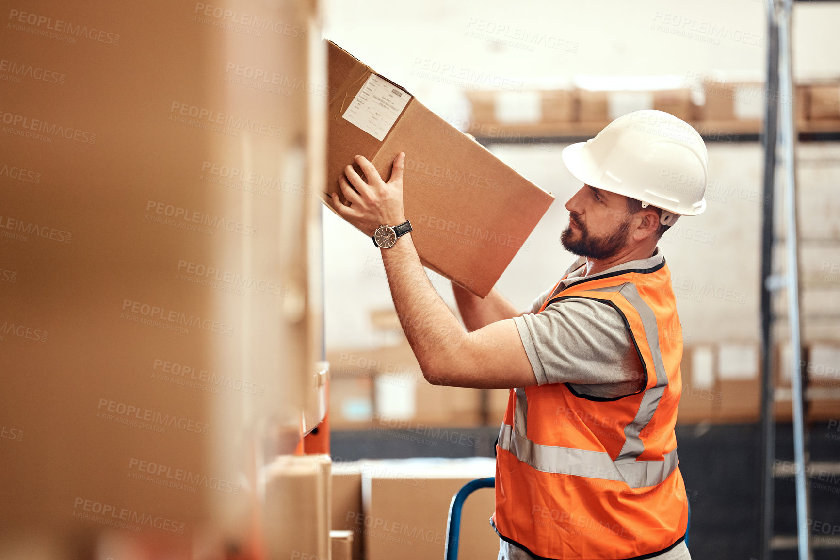 Buy stock photo Shot of a young man working in a warehouse