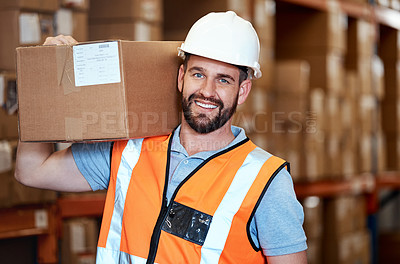 Buy stock photo Portrait of a young man holding a box while working in a warehouse