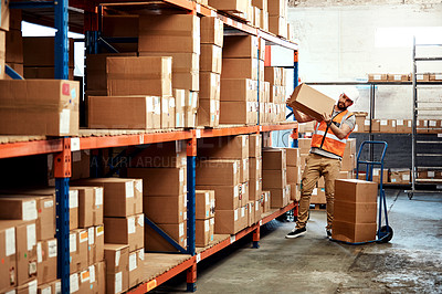 Buy stock photo Shot of a young man working in a warehouse
