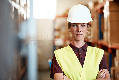 Buy stock photo Portrait of a young woman standing in a warehouse