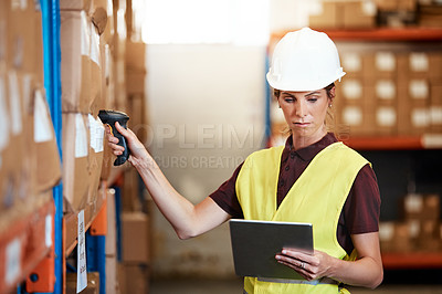Buy stock photo Shot of a young woman using a barcode reader and digital tablet in a warehouse