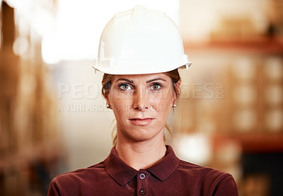 Buy stock photo Portrait of a young woman standing in a warehouse