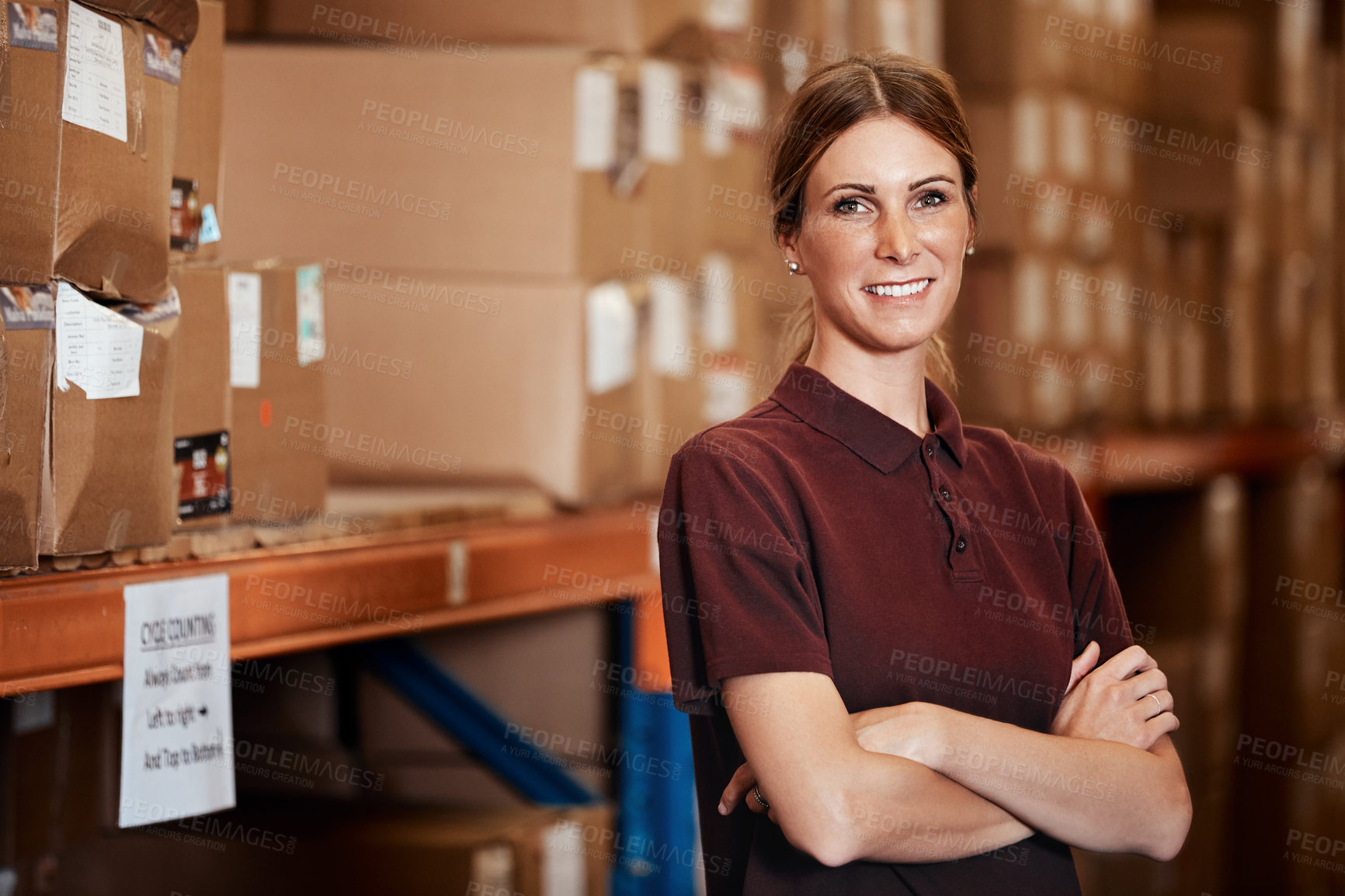 Buy stock photo Portrait of a young woman standing in a warehouse