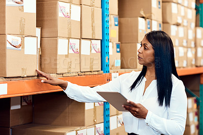 Buy stock photo Shot of a mature factory manager using a digital tablet in a warehouse