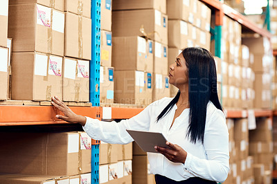 Buy stock photo Shot of a mature factory manager using a digital tablet in a warehouse