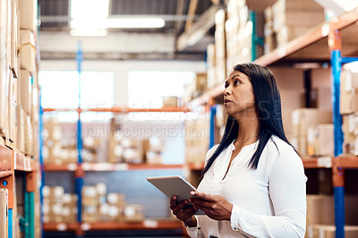 Buy stock photo Shot of a mature factory manager using a digital tablet in a warehouse