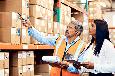 Buy stock photo Shot of a mature man and woman working together in a warehouse