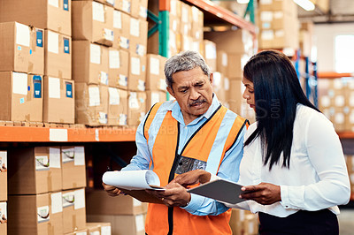 Buy stock photo Shot of a mature man and woman working together in a warehouse