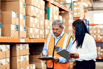 Buy stock photo Shot of a mature man and woman working together in a warehouse